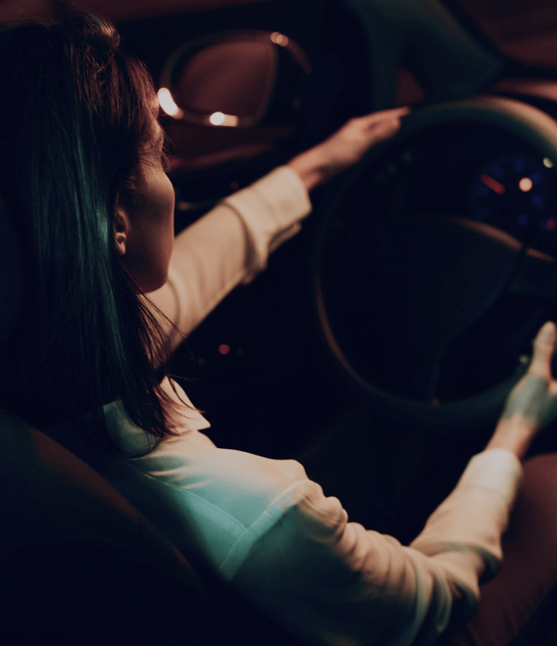 Niki driving a car, sitting in the front seat